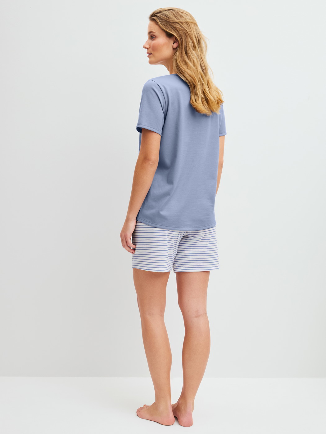 Women model is wearing Short pyjama made of 100% Cotton in Blue, Striped from the Cotton Special series by CALIDA, Back view
