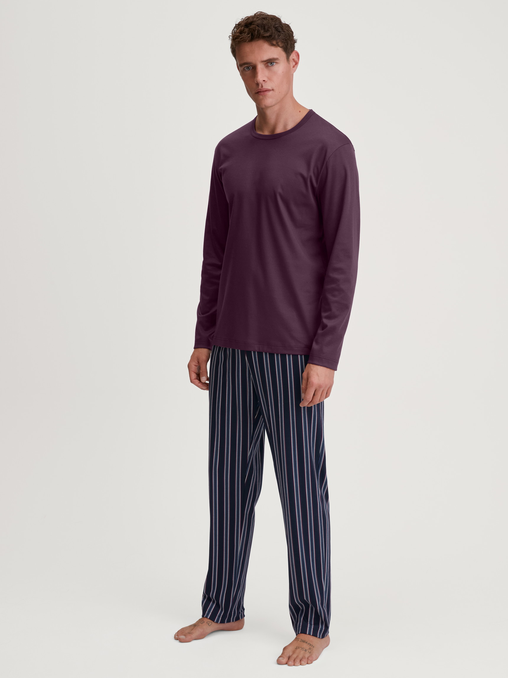 Men model is wearing Pyjamas, long made of 100% Cotton in Red, Striped from the Relax Streamline 4 series by CALIDA, Front view