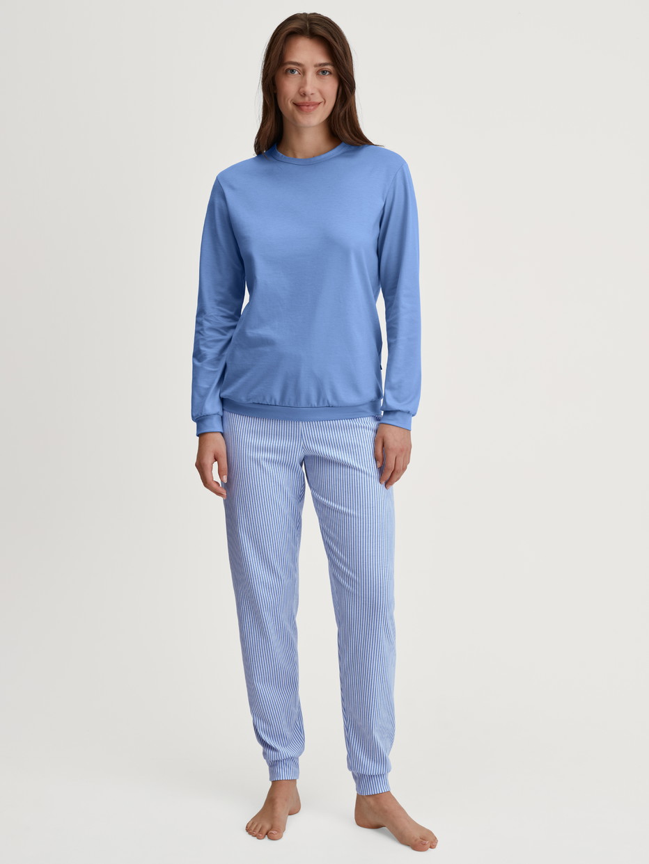 Women model is wearing Pyjama with cuff made of 100% Cotton in Blue, Patterned from the Lovely Nights series by CALIDA, Front view