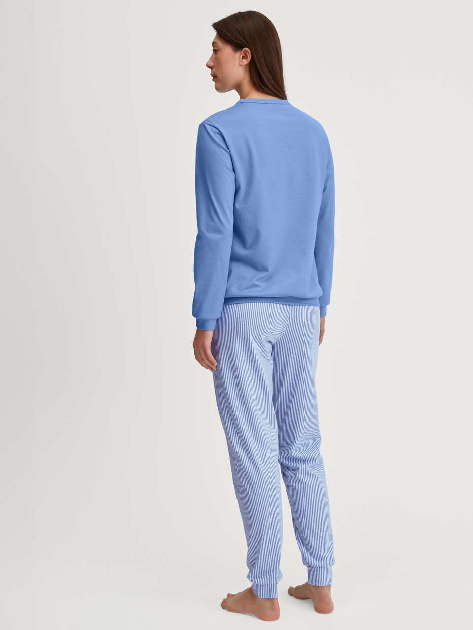 Women model is wearing Pyjama with cuff made of 100% Cotton in Blue, Patterned from the Lovely Nights series by CALIDA, Back view