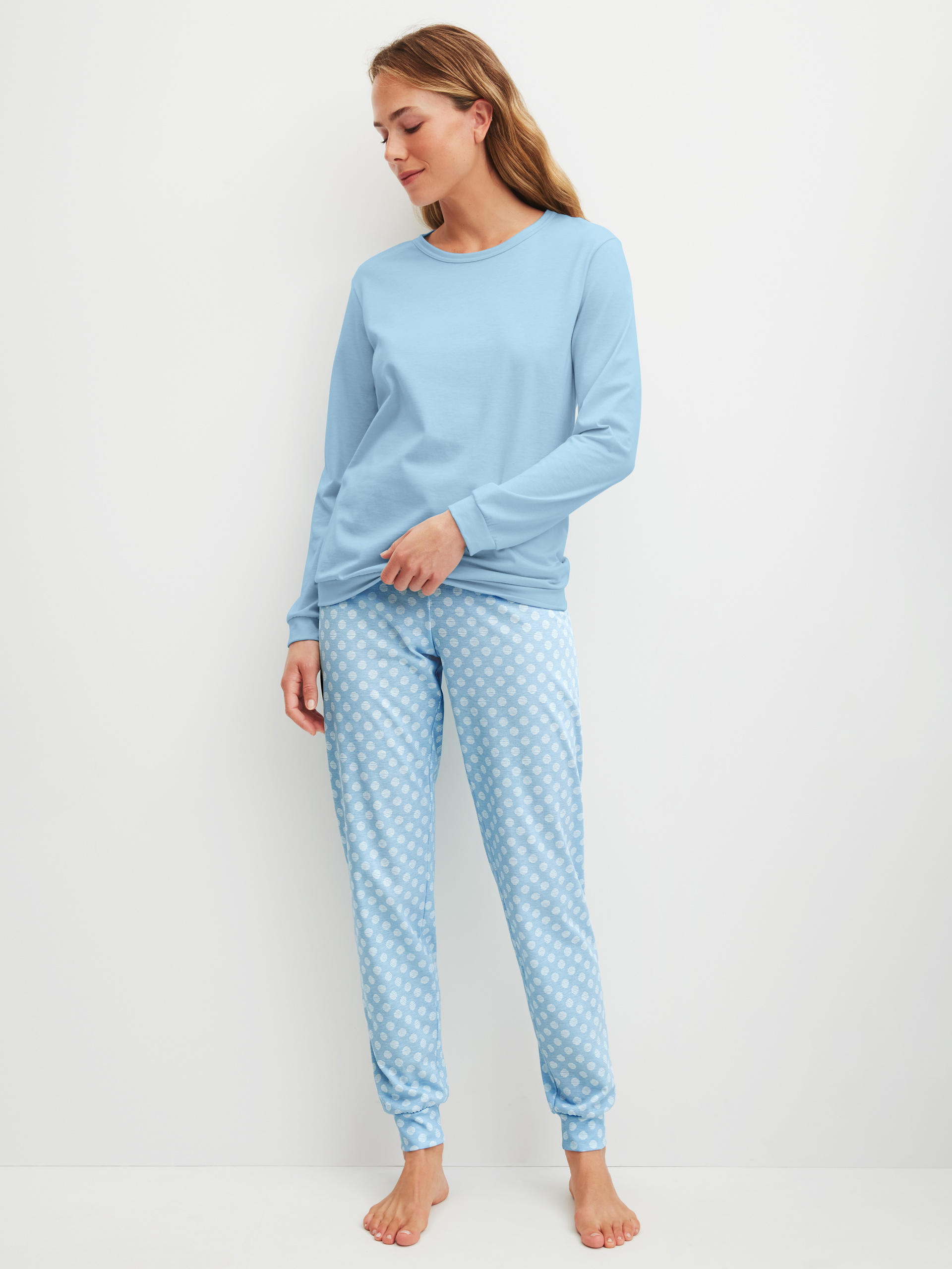 Women model is wearing Pyjama with cuff made of 100% Cotton in Blue, Patterned from the Lovely Nights series by CALIDA, Front view