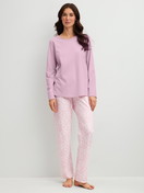 Women model is wearing Pyjamas, long made of 100% Cotton in Purple, Patterned from the Blooming Nights series by CALIDA, Front view
