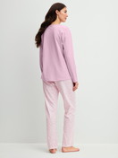 Women model is wearing Pyjamas, long made of 100% Cotton in Purple, Patterned from the Blooming Nights series by CALIDA, Back view