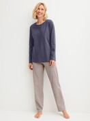 Women model is wearing Pyjamas, long made of 100% Cotton in Blue, Patterned from the Graphic Nights series by CALIDA, Front view