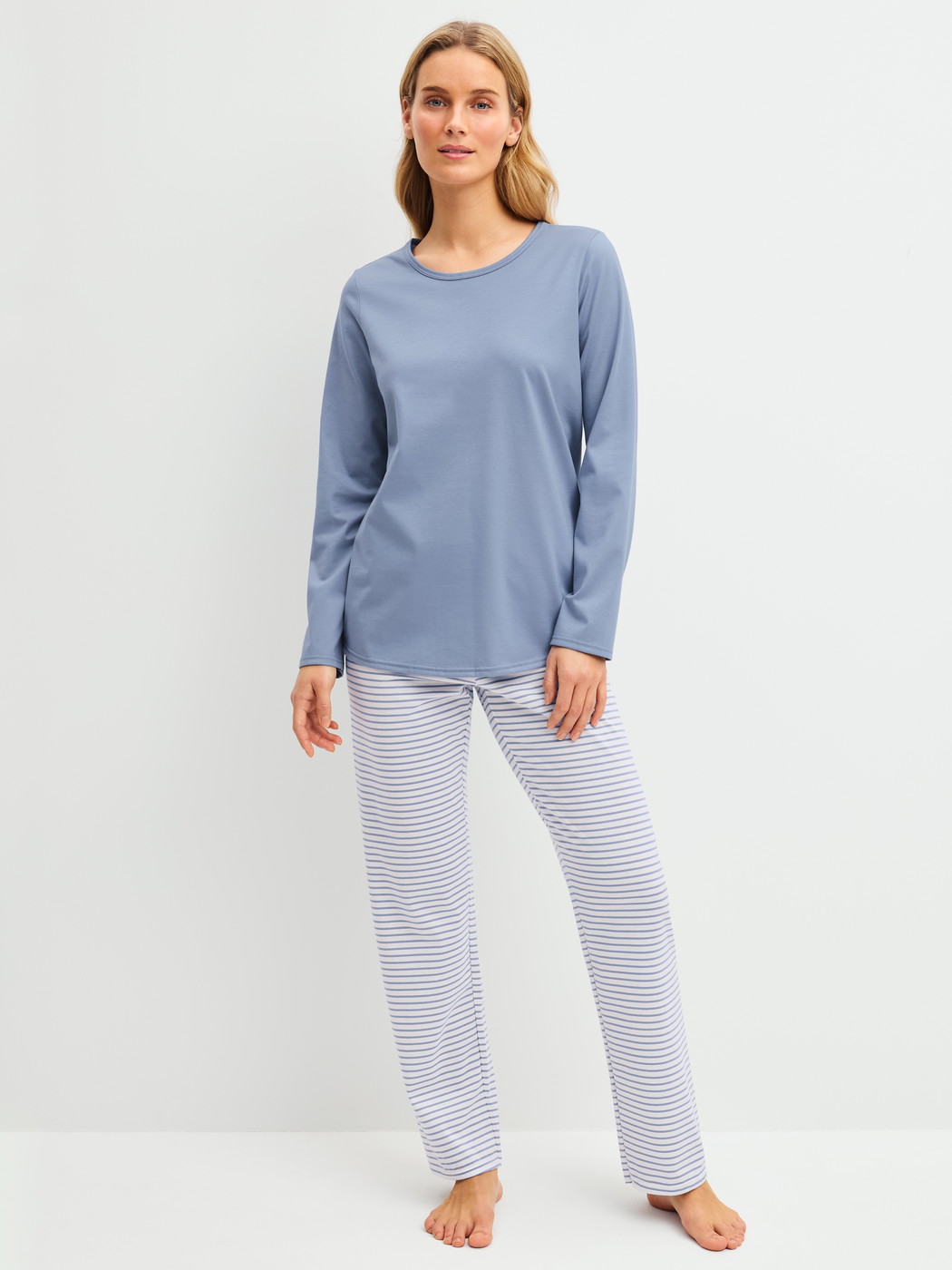 Women model is wearing Pyjamas, long made of 100% Cotton in Blue, Striped from the Cotton Special series by CALIDA, Front view