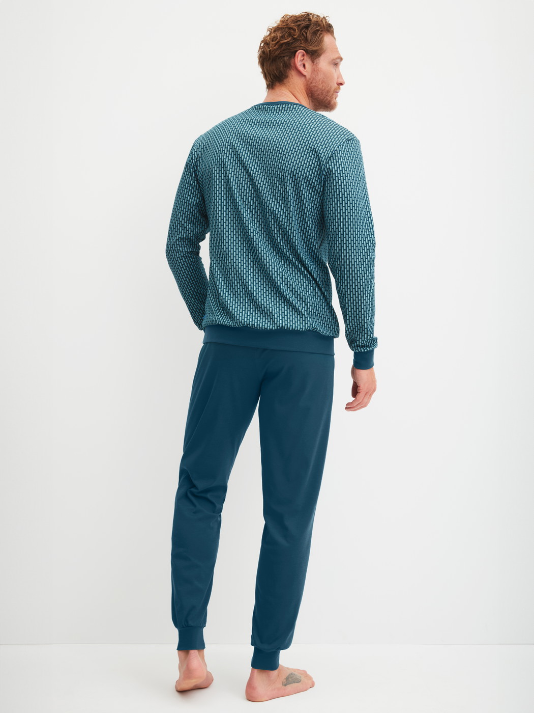 Men model is wearing Pyjama with cuff made of 100% Cotton in Turquoise, Patterned from the Relax Streamline 1 series by CALIDA, Back view