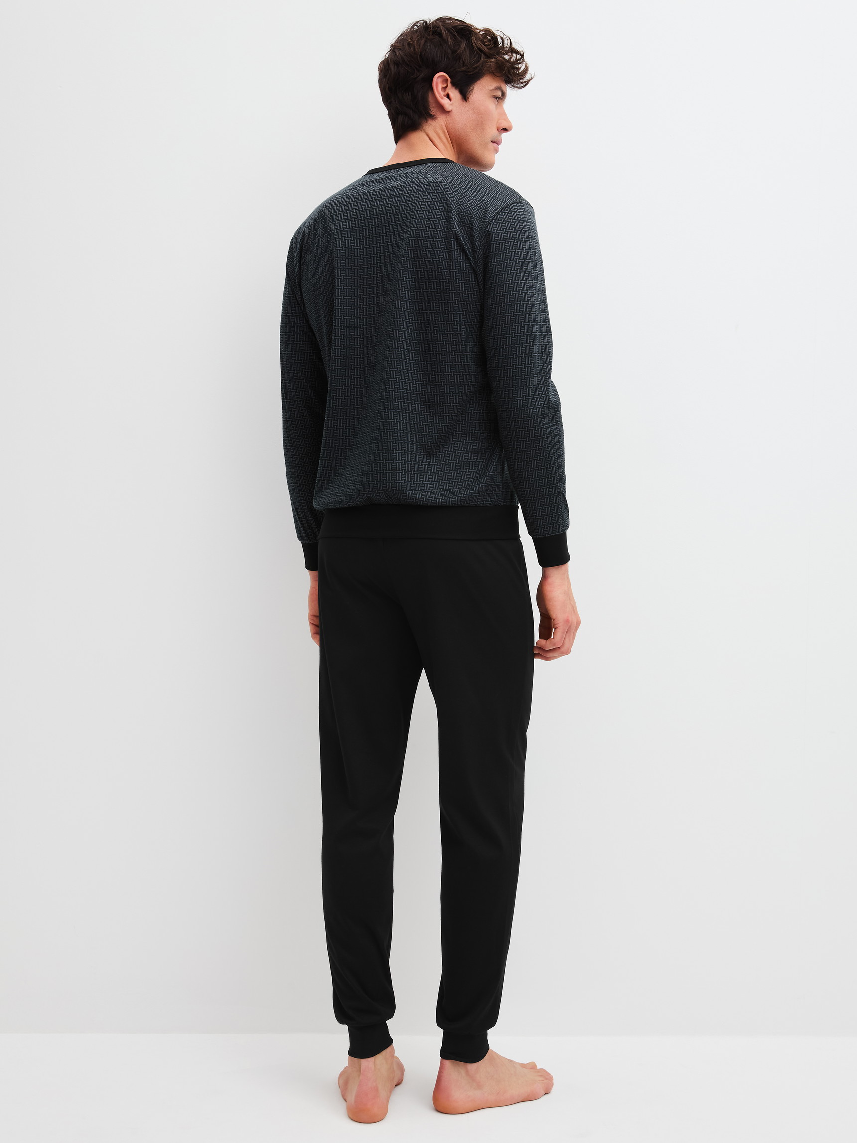 Men model is wearing Pyjama with cuff made of 100% Cotton in Black, Patterned from the Relax Streamline 2 series by CALIDA, Back view