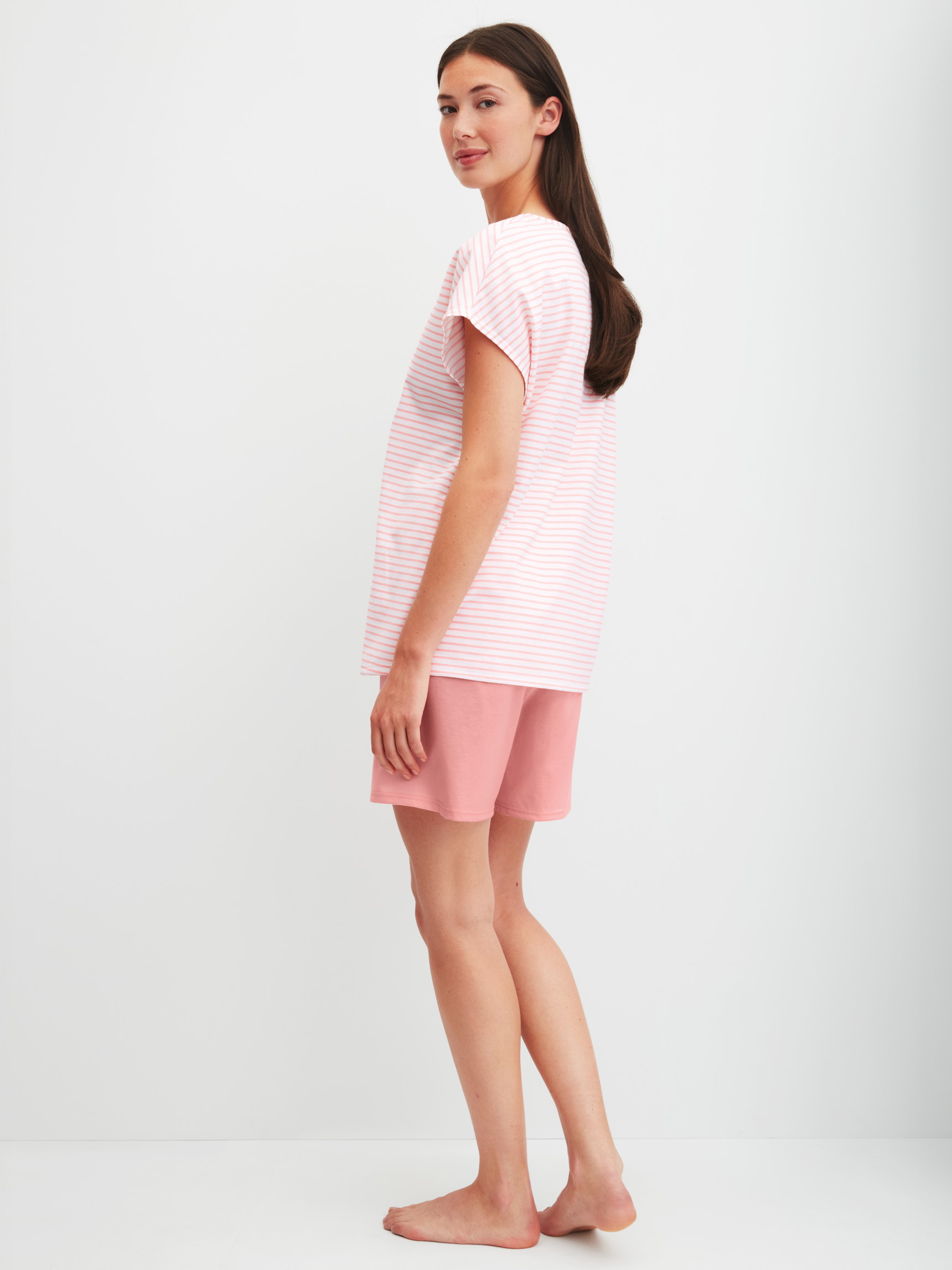 Women model is wearing Short Pyjama made of 100% Cotton in Orange, Patterned from the Lovely Nights series by CALIDA, Back view