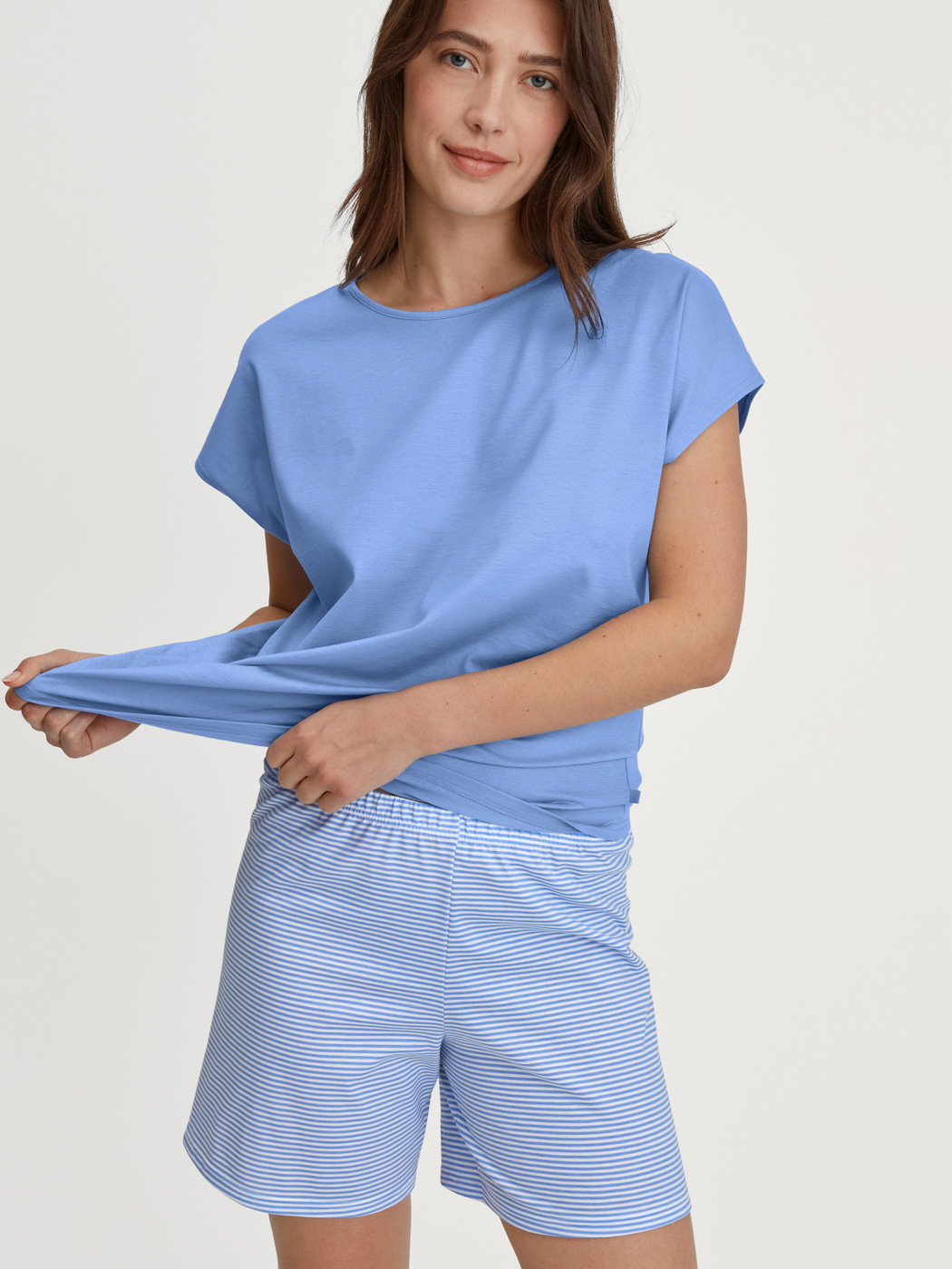 Women model is wearing Short Pyjama made of 100% Cotton in Blue, Patterned from the Lovely Nights series by CALIDA, Front view