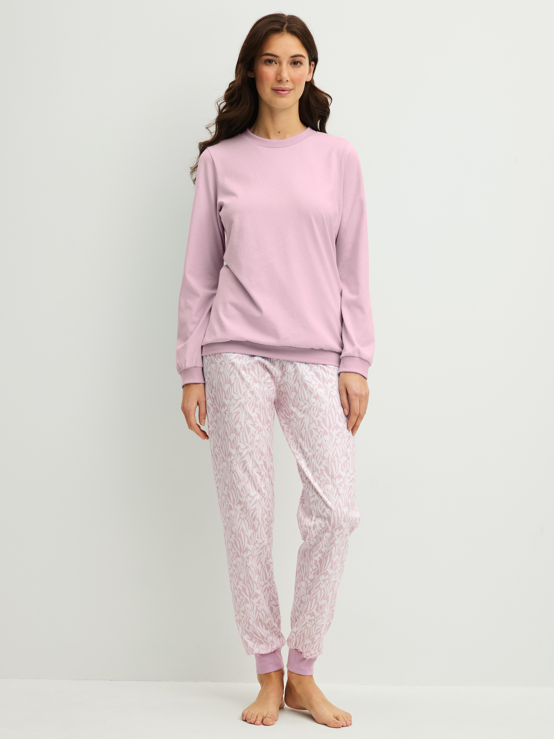 Women model is wearing Pyjama with cuff made of 100% Cotton in Purple, Patterned from the Blooming Nights series by CALIDA, Front view