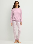 Women model is wearing Pyjama with cuff made of 100% Cotton in Purple, Patterned from the Blooming Nights series by CALIDA, Front view