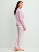 Women model is wearing Pyjama with cuff made of 100% Cotton in Purple, Patterned from the Blooming Nights series by CALIDA, Back view