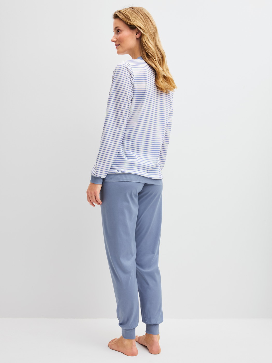 Women model is wearing Pyjama with cuff made of 100% Cotton in Blue, Striped from the Cotton Special series by CALIDA, Back view