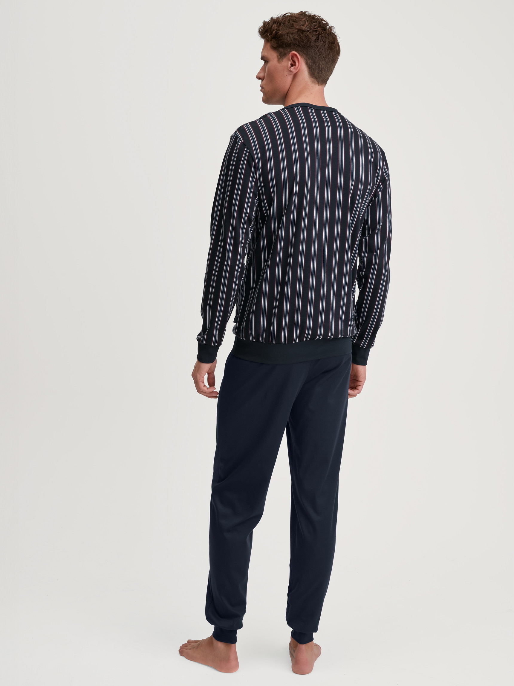 Men model is wearing Pyjama with cuff made of 100% Cotton in Blue, Striped from the Relax Streamline 4 series by CALIDA, Back view