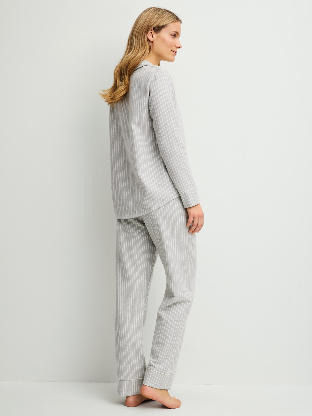 Women model is wearing Flannel pyjamas, buttoned made of 100% Cotton in Blue, Unicoloured from the Flannel Dreams series by CALIDA, Back view