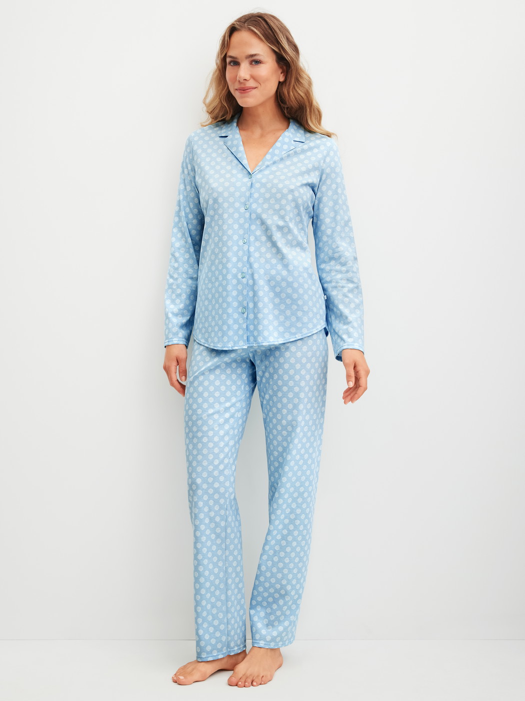 Women model is wearing Pyjama buttoned made of 100% Cotton in Blue, Patterned from the Lovely Nights series by CALIDA, Front view