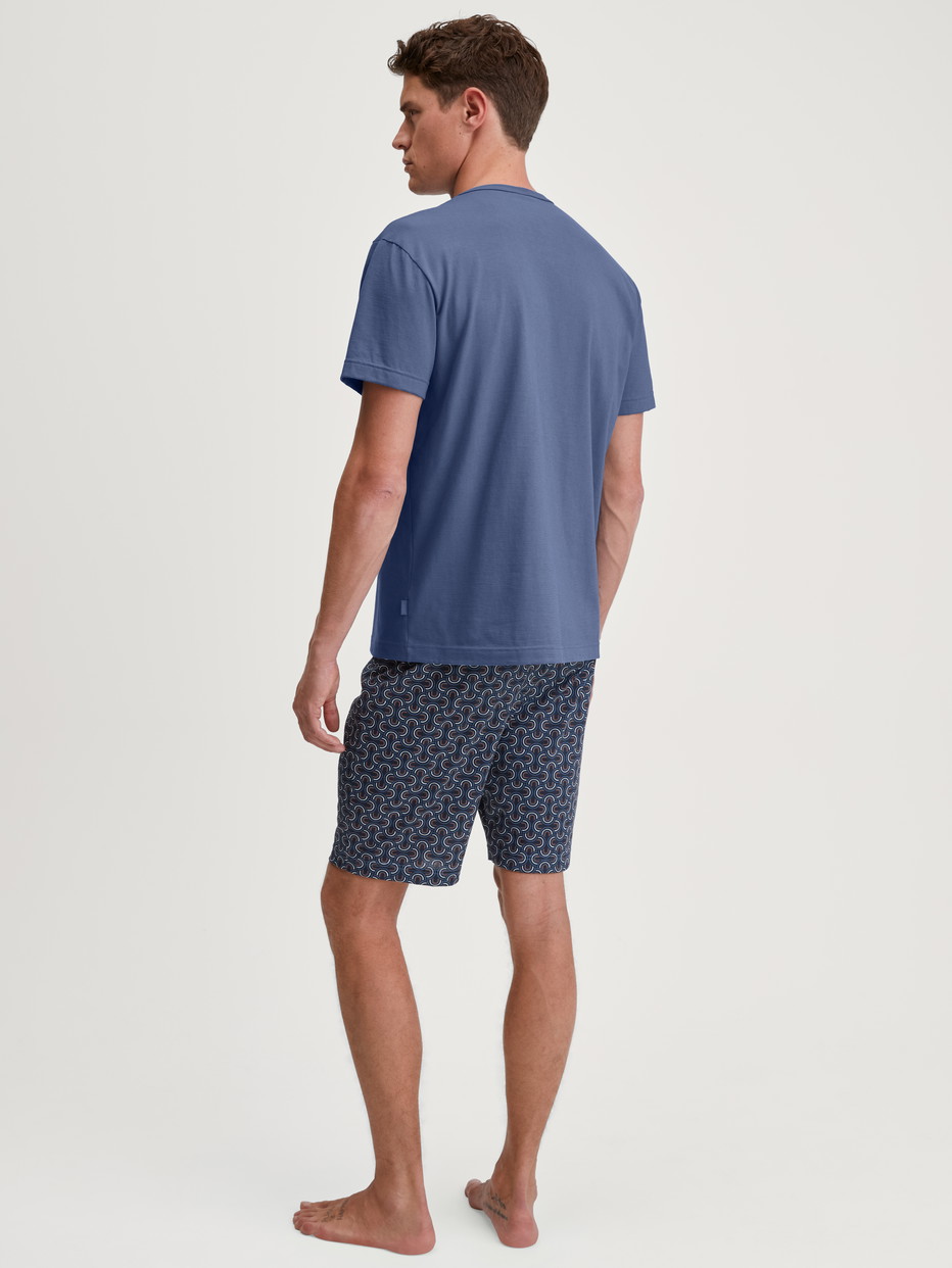 Men model is wearing Short pyjama made of 100% Cotton in Blue, Patterned from the Relax Imprint 1 series by CALIDA, Back view