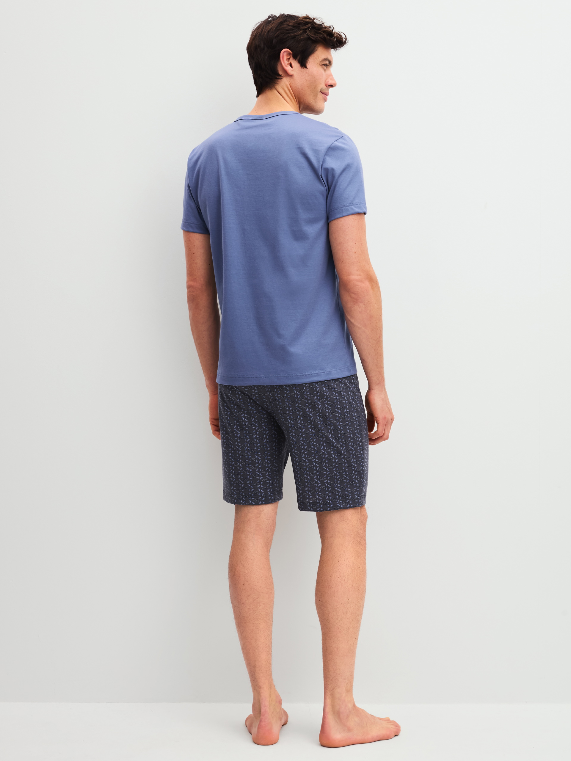 Men model is wearing Short pyjama made of 100% Cotton in Blue, Patterned from the Relax Imprint 1 series by CALIDA, Back view