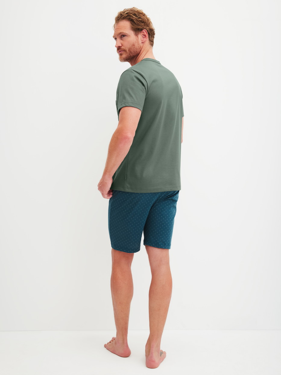Herren-Model trägt Kurz-Pyjama aus 100% Baumwolle in Grün, Gemustert aus Serie Relax Imprint 1 von CALIDA, Rückansicht