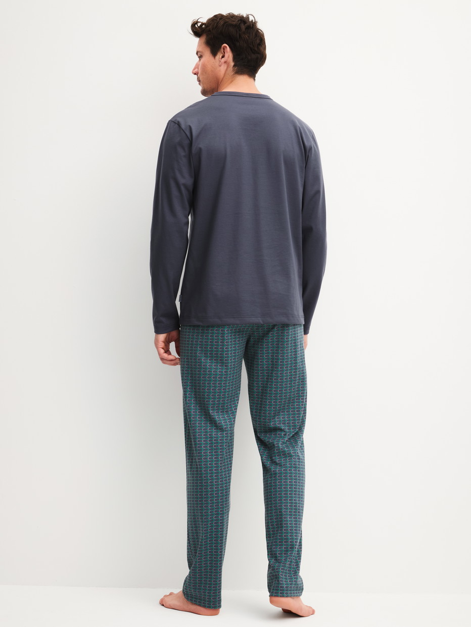 Men model is wearing Pyjamas, long made of 100% Cotton in Black, Patterned from the Cotton Special series by CALIDA, Back view