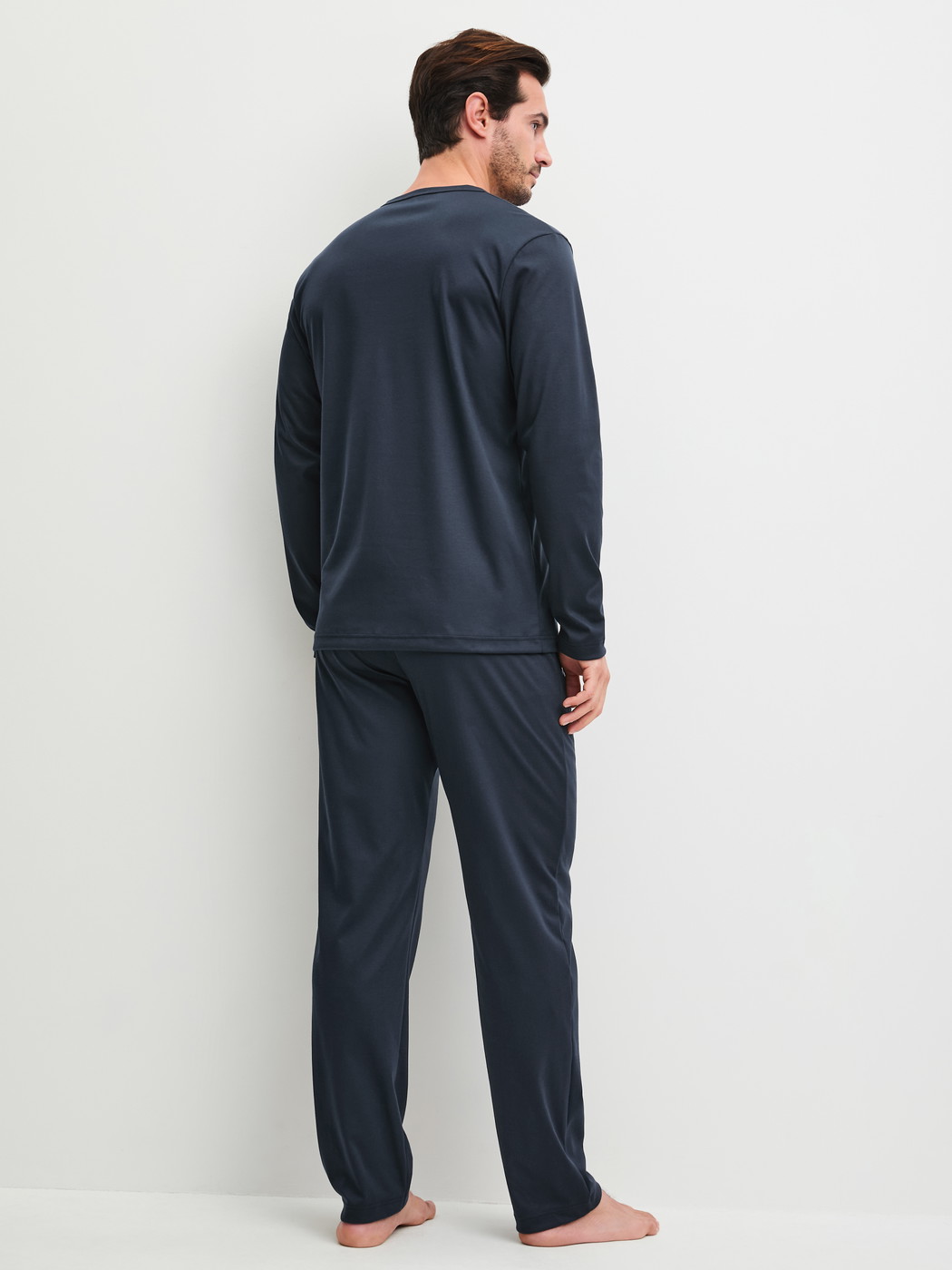 Men model is wearing Pyjamas made of 100% Cotton in Blue, Patterned from the EDITION 85 series by CALIDA, Back view