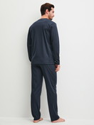 Men model is wearing Pyjamas made of 100% Cotton in Blue, Patterned from the EDITION 85 series by CALIDA, Back view