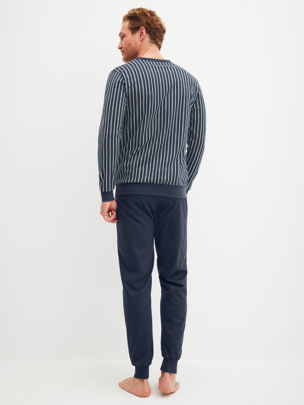 Men model is wearing Pyjama with cuff made of 100% Cotton in Blue, Patterned from the Cotton Special series by CALIDA, Back view