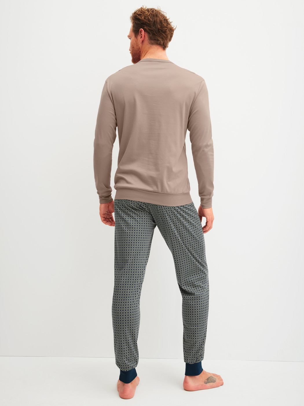 Men model is wearing cuffed pyjamas made of 100% Cotton in Blue, Patterned from the Relax Choice 1 series by CALIDA, Back view