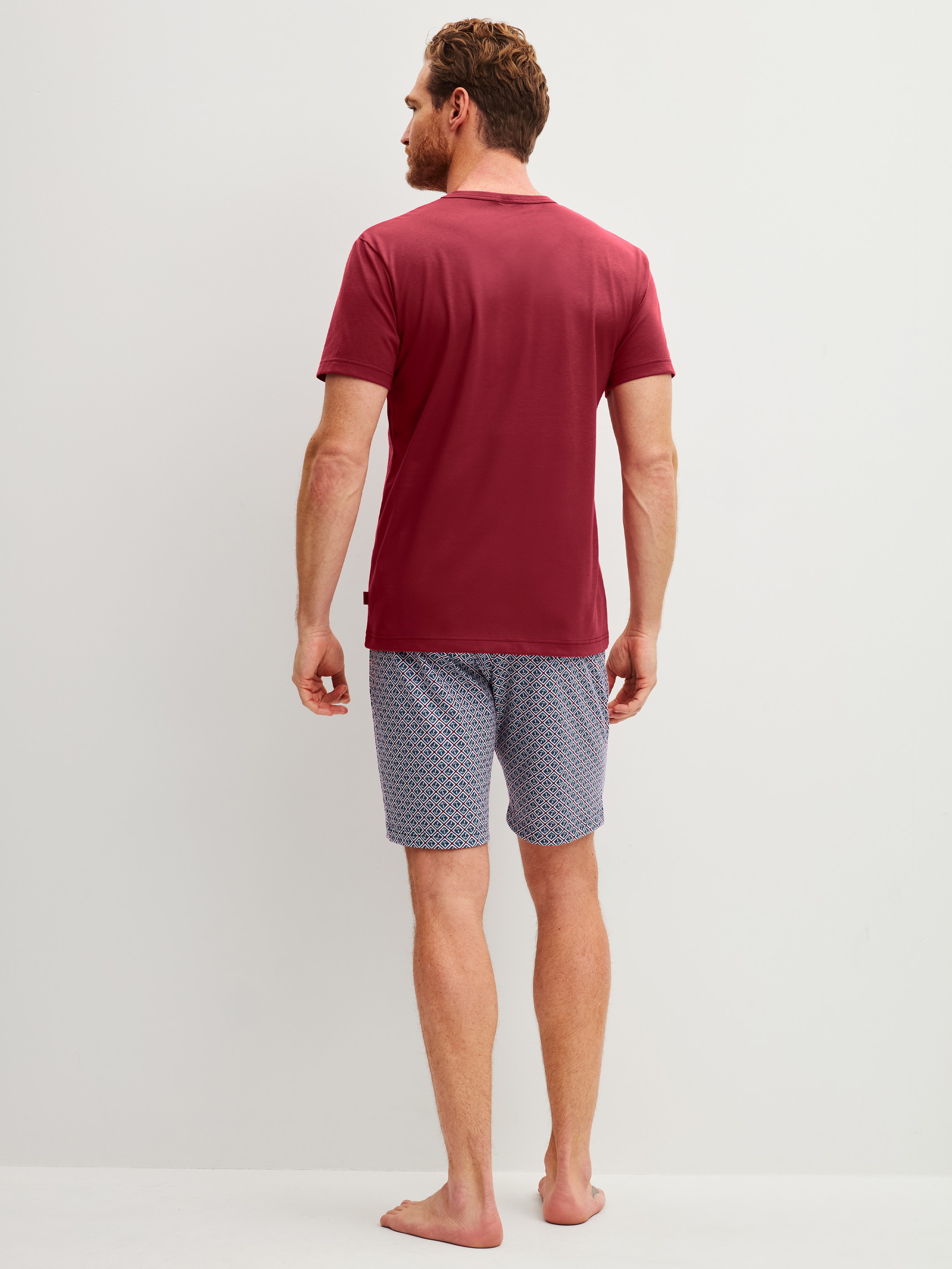 Herren-Model trägt Kurz-Pyjama aus 100% Baumwolle in Rot, Gemustert aus Serie Cotton Special von CALIDA, Rückansicht