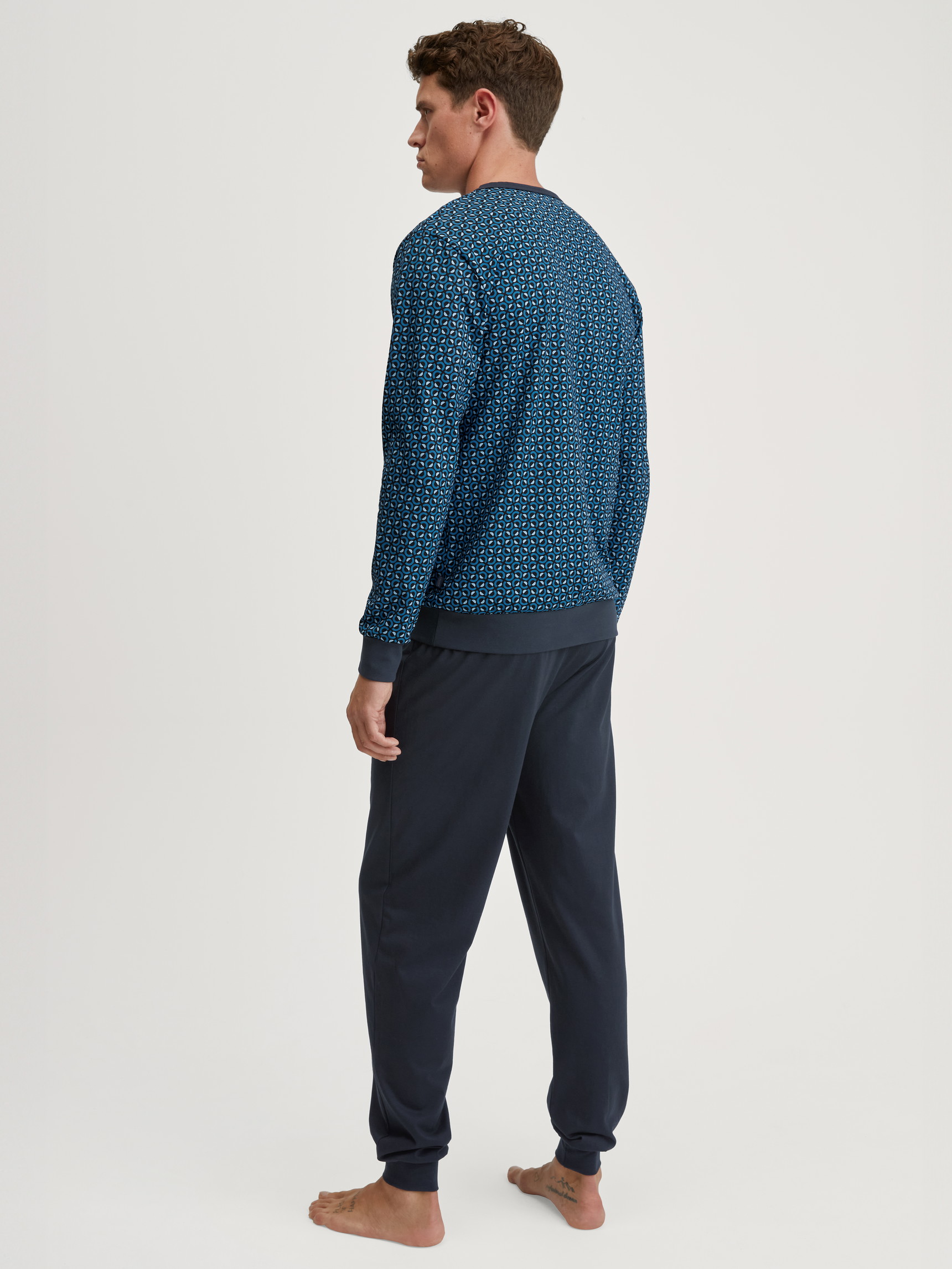 Men model is wearing Pyjama with cuff made of 100% Cotton in Blue, Patterned from the Relax Imprint 2 series by CALIDA, Back view