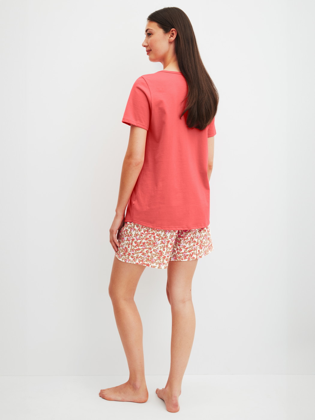 Damen-Model trägt Kurz-Pyjama aus 100% Baumwolle in Rot, Floral aus Serie Flower Nights von CALIDA, Rückansicht