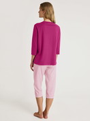 Women model is wearing Capri Pyjama made of 100% Cotton in Red, Striped from the Cotton Special series by CALIDA, Back view