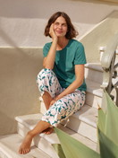 Women model is wearing 7/8 - Pyjamas made of 100% Cotton in Turquoise, Floral from the Botanic Dreams series by CALIDA, Front view
