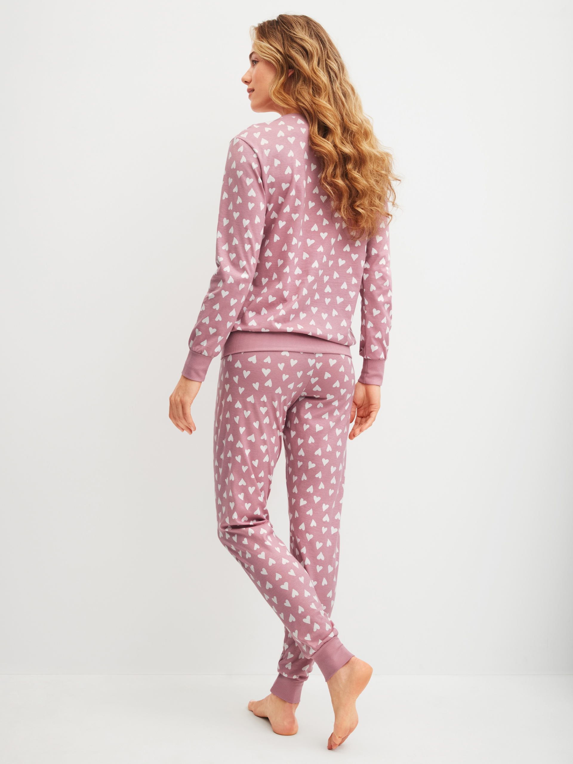 Women model is wearing Pyjama with cuff made of 100% Cotton in Pink, Patterned from the Cotton Special series by CALIDA, Back view