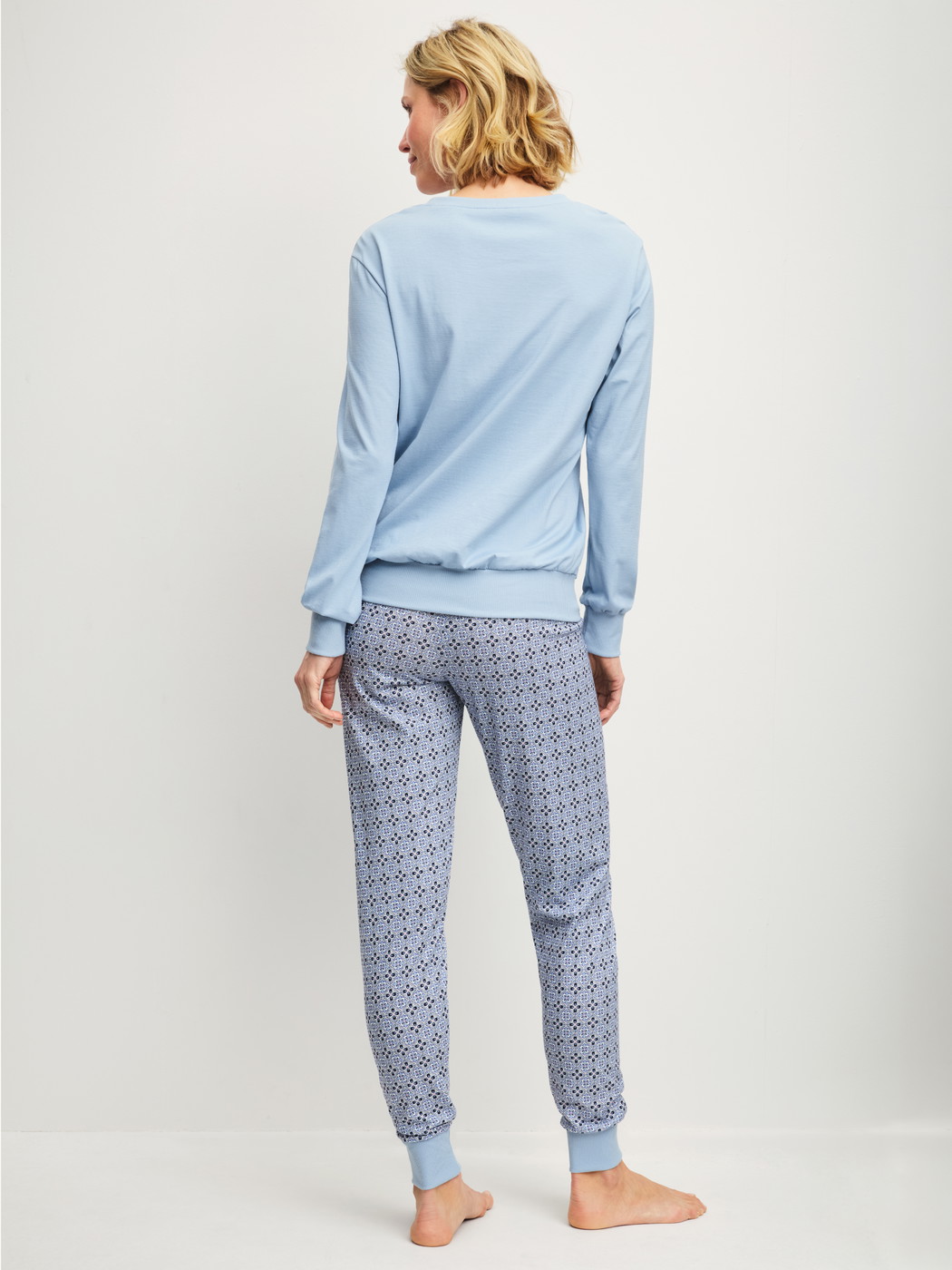 Women model is wearing Pyjama with cuff made of 100% Cotton in Grey, Patterned from the Cotton Special series by CALIDA, Back view