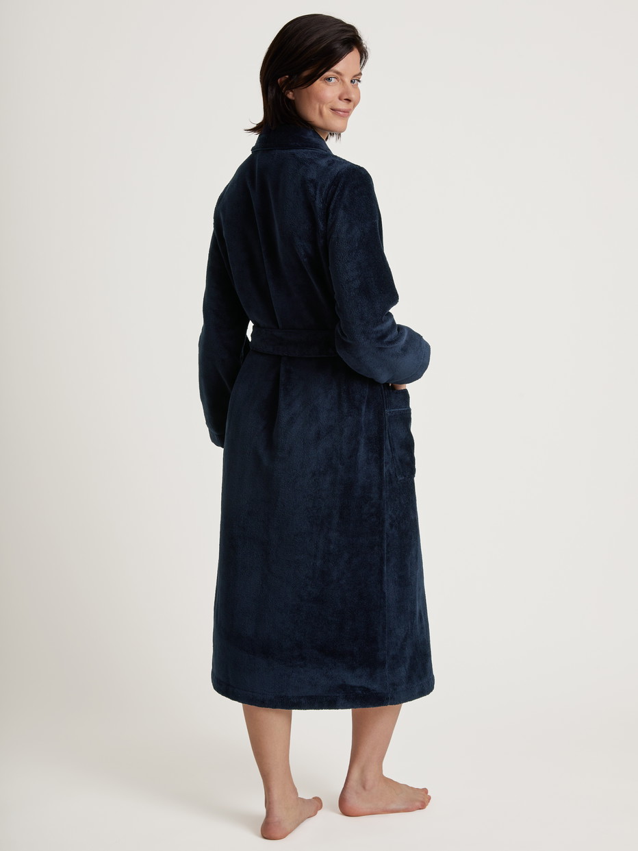 Women model is wearing Bathrobe made of Cotton in Blue, Unicoloured from the Cosy Shower series by CALIDA, Back view